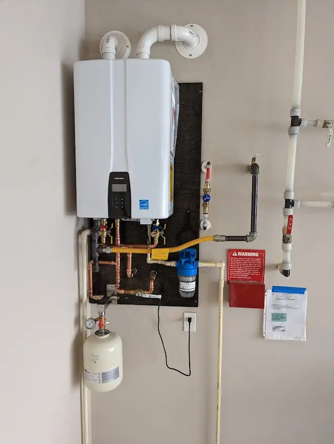 Professional plumber installing copper piping in a Lower Burrell home